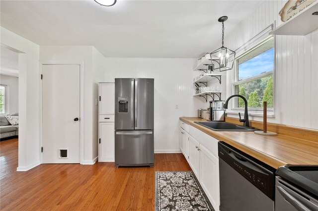 3702 School Rd, Murrysville, PA 15668 - kitchen with stainless steel appliances, a sink, open shelves, light wood-style flooring, and healthy amount of natural light