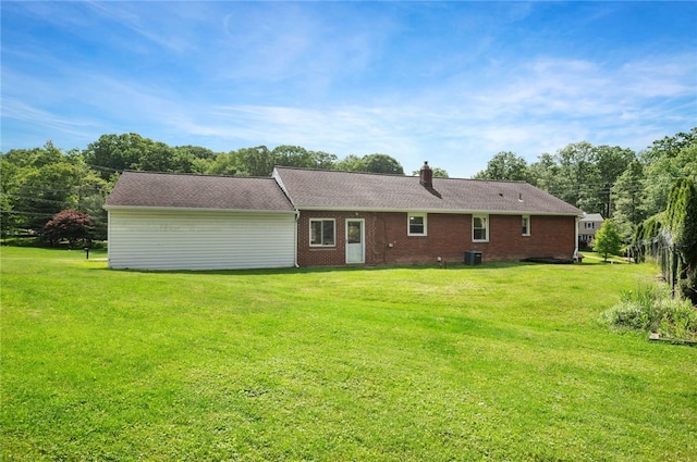 3702 School Rd, Murrysville, PA 15668 - back of property featuring a yard, brick siding, a chimney, and central AC