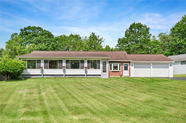 3702 School Rd, Murrysville, PA 15668 - view of front of property featuring a garage, asphalt driveway, a front yard, and a sunroom