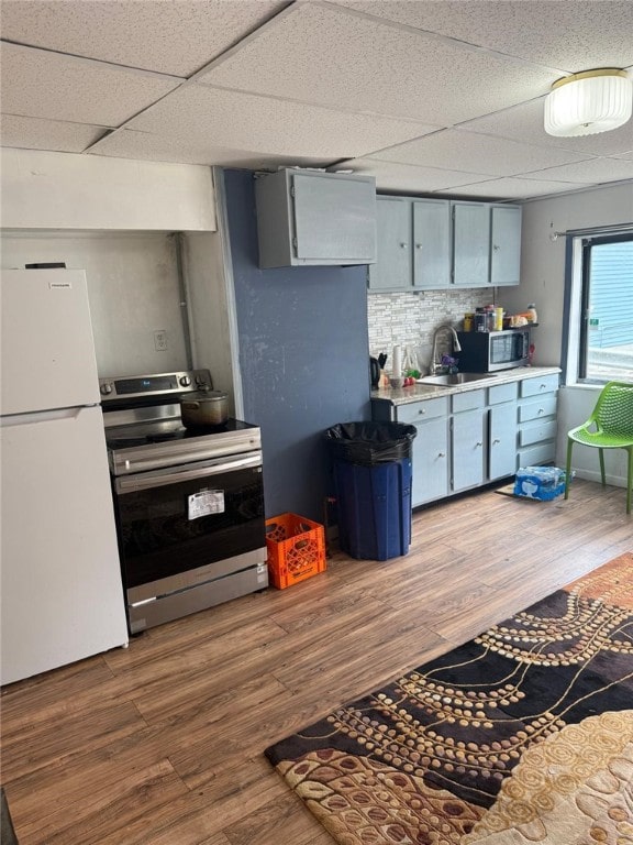 1704 High St, Spring Garden, PA 15212 - kitchen featuring stainless steel appliances, wood finished floors, light countertops, a paneled ceiling, and a sink