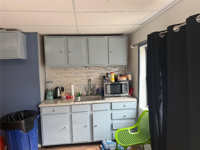 1704 High St, Spring Garden, PA 15212 - kitchen with a sink, stainless steel microwave, gray cabinetry, a paneled ceiling, and backsplash