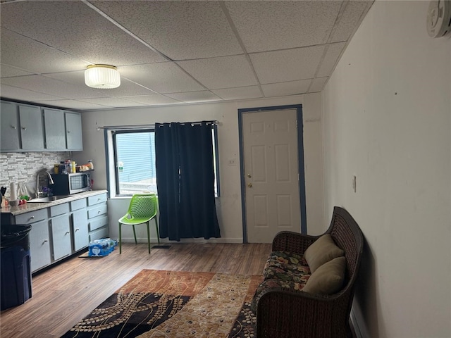 1704 High St, Spring Garden, PA 15212 - living area featuring light wood-style floors, a drop ceiling, and baseboards