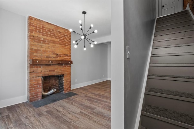 2532 Larkins Way S, Side, PA 15203 - stairway featuring wood finished floors, baseboards, a chandelier, and a fireplace