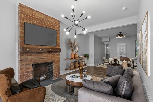 2532 Larkins Way S, Side, PA 15203 - living area featuring wood finished floors, a chandelier, a fireplace, and baseboards