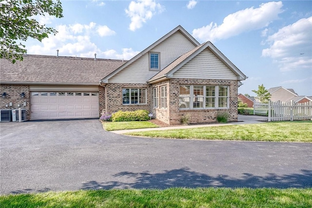 4115 Duckhorn Dr, Moon/Crescent Twp, PA 15108 - view of front of property featuring brick siding, a garage, driveway, and central air condition unit