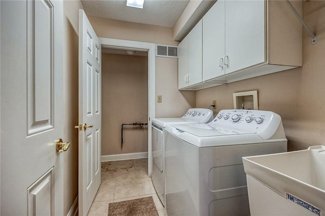 4115 Duckhorn Dr, Moon/Crescent Twp, PA 15108 - laundry room featuring cabinet space, washer and dryer, baseboards, a textured ceiling, and light tile patterned floors