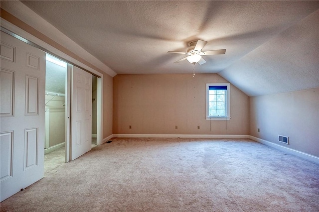 4115 Duckhorn Dr, Moon/Crescent Twp, PA 15108 - unfurnished bedroom with a textured ceiling, light carpet, lofted ceiling, baseboards, and ceiling fan
