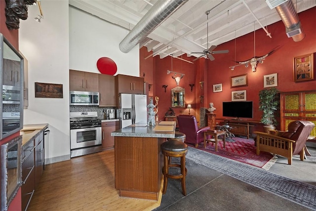 1536 Colwell St Unit 4, Downtown Pgh, PA 15219 - kitchen with appliances with stainless steel finishes, a towering ceiling, ceiling fan, tasteful backsplash, and open floor plan