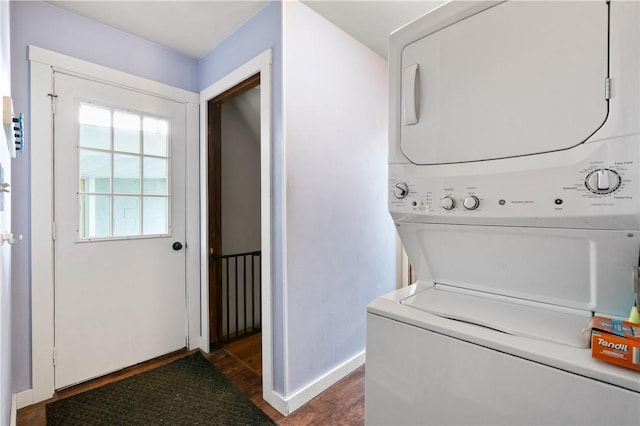 988 Croft Rd, Salem Twp Wml, PA 15601 - laundry room featuring stacked washer and clothes dryer, dark wood finished floors, and baseboards
