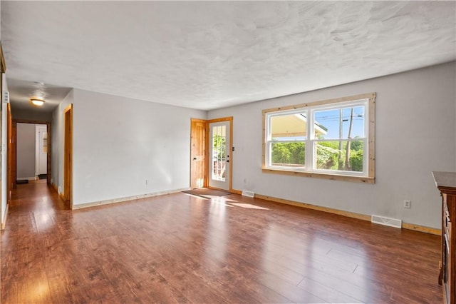 988 Croft Rd, Salem Twp Wml, PA 15601 - unfurnished living room featuring baseboards, wood finished floors, and a textured ceiling