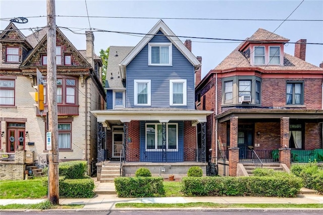1105 Chislett St, Morningside, PA 15206 - view of front facade with covered porch, brick siding, and a chimney