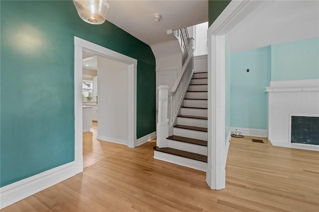1105 Chislett St, Morningside, PA 15206 - stairway featuring wood finished floors, baseboards, and a tile fireplace