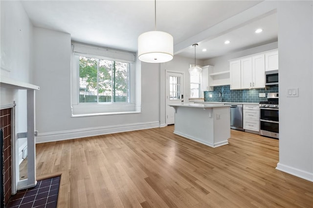 1105 Chislett St, Morningside, PA 15206 - kitchen featuring stainless steel appliances, white cabinetry, light wood-type flooring, light countertops, and recessed lighting