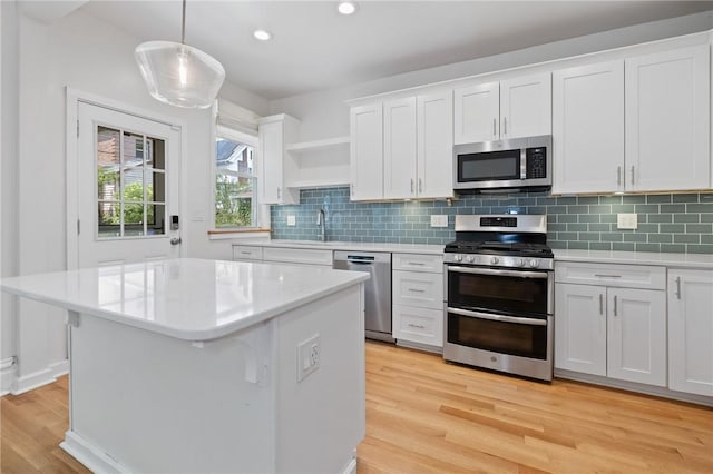 1105 Chislett St, Morningside, PA 15206 - kitchen featuring stainless steel appliances, light countertops, light wood finished floors, open shelves, and white cabinets