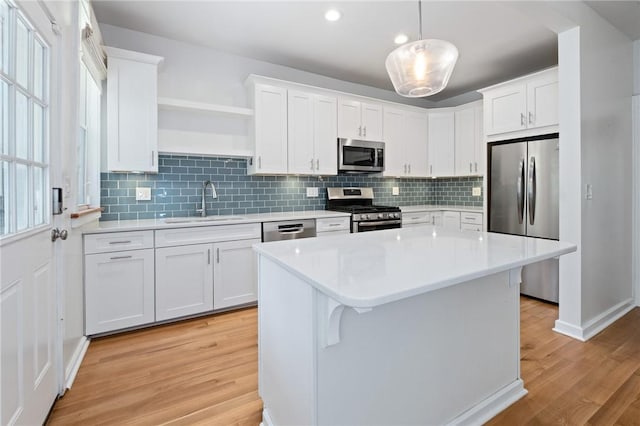 1105 Chislett St, Morningside, PA 15206 - kitchen with stainless steel appliances, light wood finished floors, a sink, light countertops, and recessed lighting