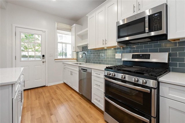 1105 Chislett St, Morningside, PA 15206 - kitchen featuring appliances with stainless steel finishes, a sink, light countertops, and light wood-style flooring