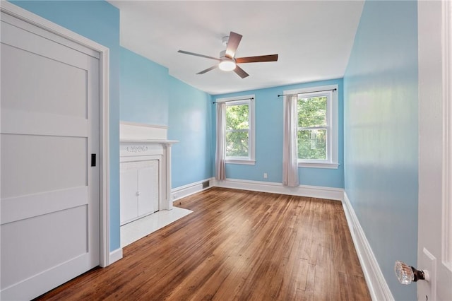 1105 Chislett St, Morningside, PA 15206 - unfurnished living room featuring wood-type flooring, ceiling fan, and baseboards