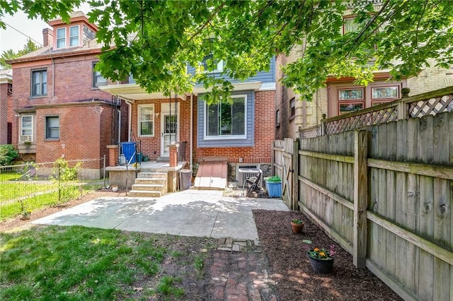 1105 Chislett St, Morningside, PA 15206 - back of house featuring brick siding, a fenced backyard, and a patio area