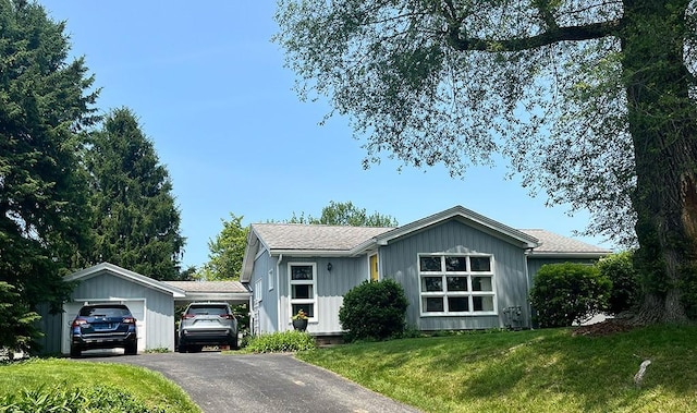 1720 Saltsburg Ave, White Twp Ind, PA 15701 - view of front of property featuring a front lawn, a garage, board and batten siding, and asphalt driveway