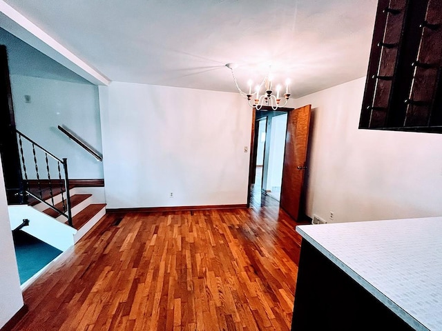 1720 Saltsburg Ave, White Twp Ind, PA 15701 - unfurnished dining area with a chandelier, wood finished floors, stairway, and baseboards
