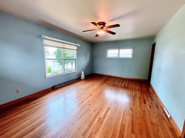 1720 Saltsburg Ave, White Twp Ind, PA 15701 - empty room featuring a baseboard heating unit, wood finished floors, a ceiling fan, and baseboards
