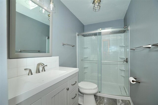 317 Fairview Dr, Manor, PA 15642 - bathroom with a stall shower, toilet, vanity, decorative backsplash, and marble look tile flooring
