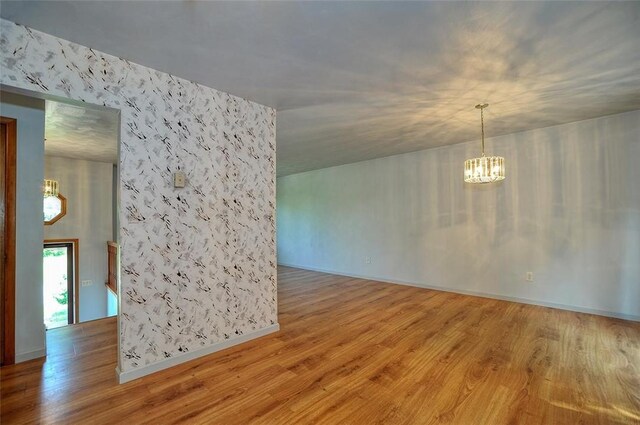 317 Fairview Dr, Manor, PA 15642 - spare room with a chandelier and wood finished floors