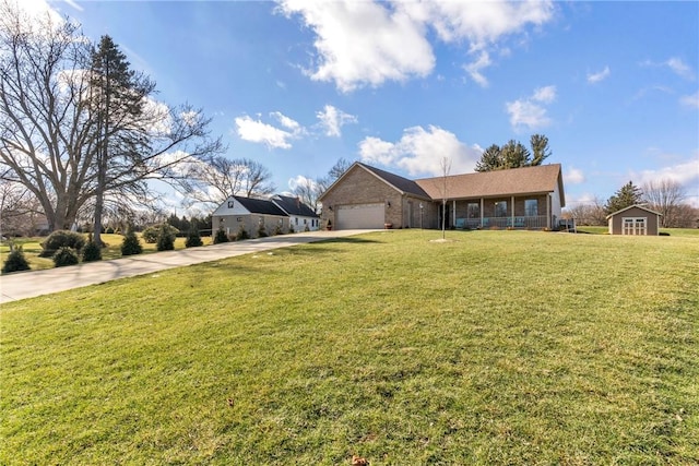 2246 Shannon Mills Dr, Connoquenessing Twp, PA 16053 - ranch-style house with driveway, an attached garage, a front lawn, brick siding, and a porch
