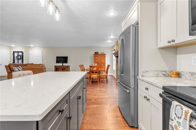 2246 Shannon Mills Dr, Connoquenessing Twp, PA 16053 - kitchen with freestanding refrigerator, light wood-style floors, white cabinetry, recessed lighting, and a kitchen island