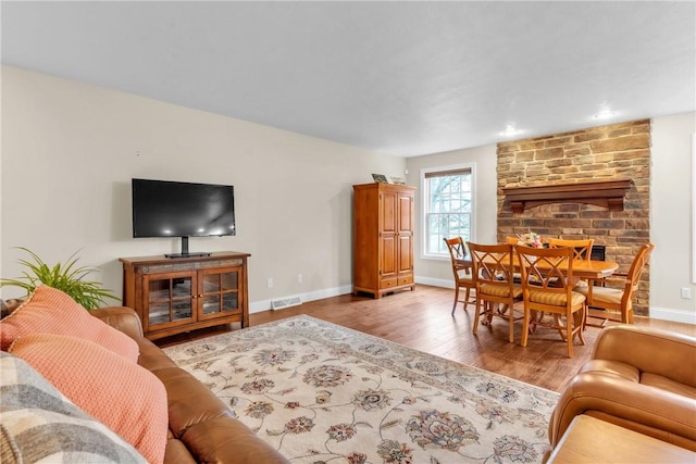 2246 Shannon Mills Dr, Connoquenessing Twp, PA 16053 - living room with wood finished floors, baseboards, and a fireplace
