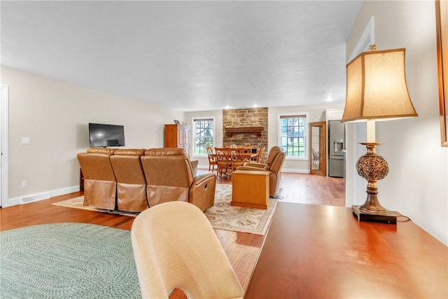 2246 Shannon Mills Dr, Connoquenessing Twp, PA 16053 - dining space featuring light wood-type flooring, a fireplace, and baseboards