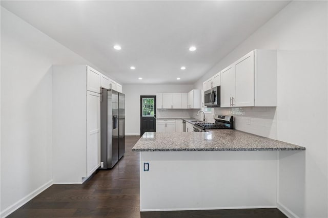 80 Butler St, Valencia Boro, PA 16059 - kitchen featuring appliances with stainless steel finishes, a peninsula, white cabinets, a sink, and light stone countertops