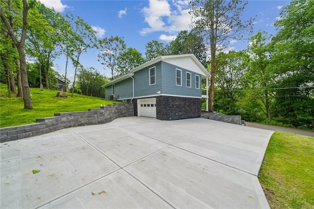 80 Butler St, Valencia Boro, PA 16059 - view of property exterior with stone siding, concrete driveway, an attached garage, and a yard