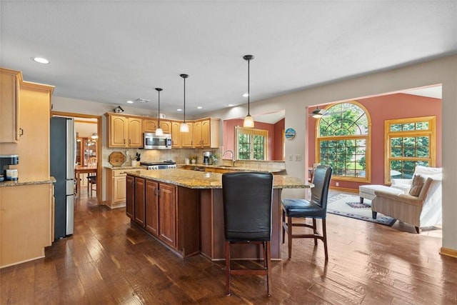 1616 Norman Dr, Franklin Park, PA 15143 - kitchen featuring appliances with stainless steel finishes, dark wood-type flooring, recessed lighting, backsplash, and light stone counters