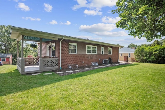 162 E Wedgewood Dr, Ross Twp, PA 15229 - back of house featuring brick siding, a yard, central AC, and an outbuilding