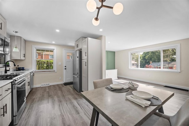 162 E Wedgewood Dr, Ross Twp, PA 15229 - kitchen with appliances with stainless steel finishes, healthy amount of natural light, wood finished floors, and recessed lighting