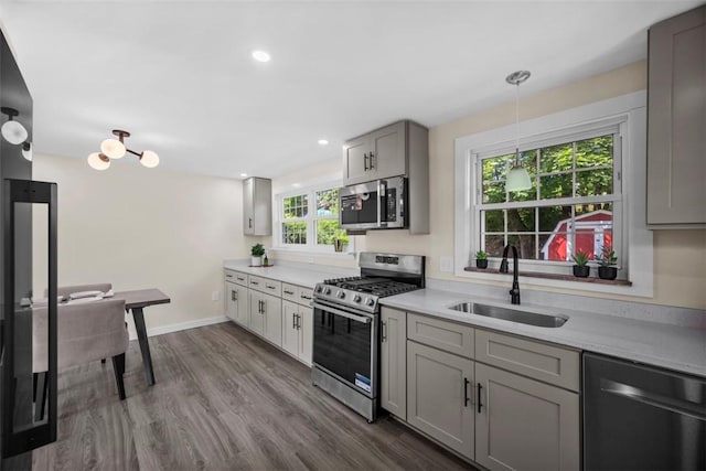 162 E Wedgewood Dr, Ross Twp, PA 15229 - kitchen with appliances with stainless steel finishes, a sink, light countertops, dark wood-style flooring, and recessed lighting