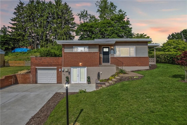 162 E Wedgewood Dr, Ross Twp, PA 15229 - view of front of property featuring concrete driveway, brick siding, an attached garage, and french doors