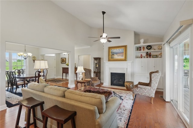 112 Savannah Dr, Lancaster Twp, PA 16037 - living room with a fireplace with flush hearth, wood finished floors, a chandelier, ceiling fan, and high vaulted ceiling