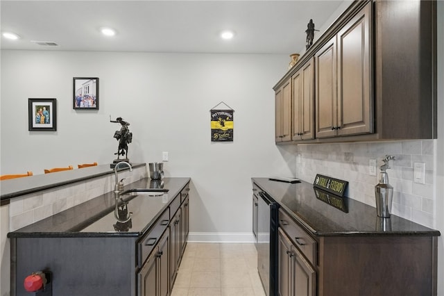 112 Savannah Dr, Lancaster Twp, PA 16037 - kitchen with a peninsula, baseboards, backsplash, dark stone counters, and recessed lighting
