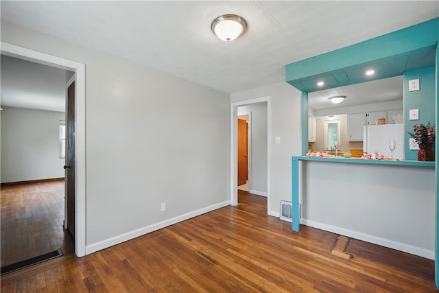 131 Spring Ave, Bellevue, PA 15202 - unfurnished living room featuring wood-type flooring, baseboards, and recessed lighting