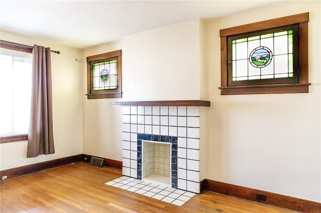 315 Wright St, Mckees Rocks, PA 15136 - detailed view of baseboards, wood finished floors, and a fireplace