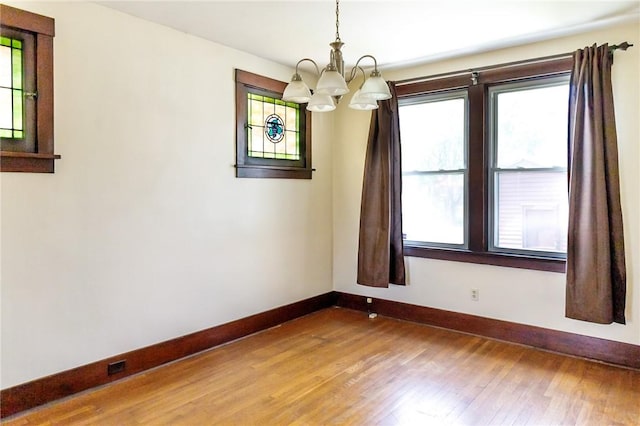315 Wright St, Mckees Rocks, PA 15136 - spare room with baseboards, a chandelier, and light wood-type flooring