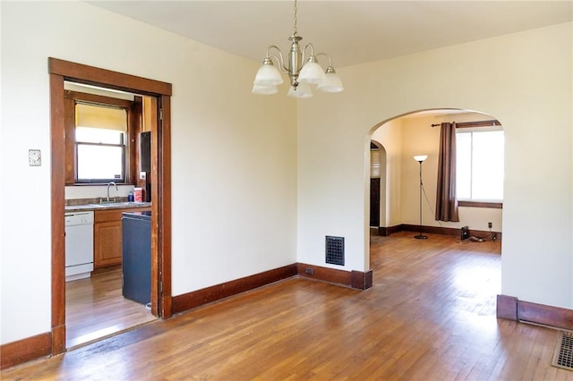 315 Wright St, Mckees Rocks, PA 15136 - spare room with light wood finished floors, arched walkways, a chandelier, and a sink