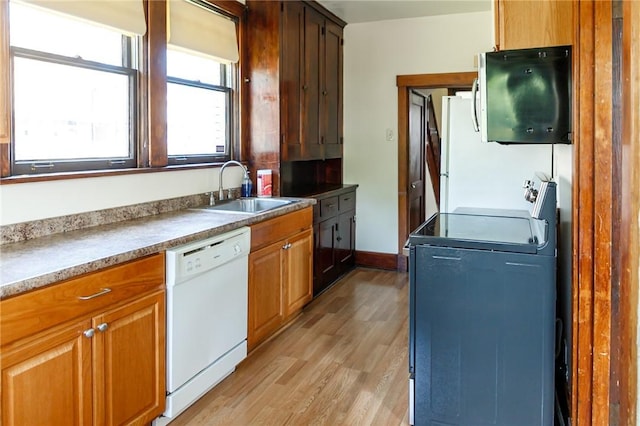 315 Wright St, Mckees Rocks, PA 15136 - kitchen featuring white appliances, a sink, light wood finished floors, and brown cabinetry