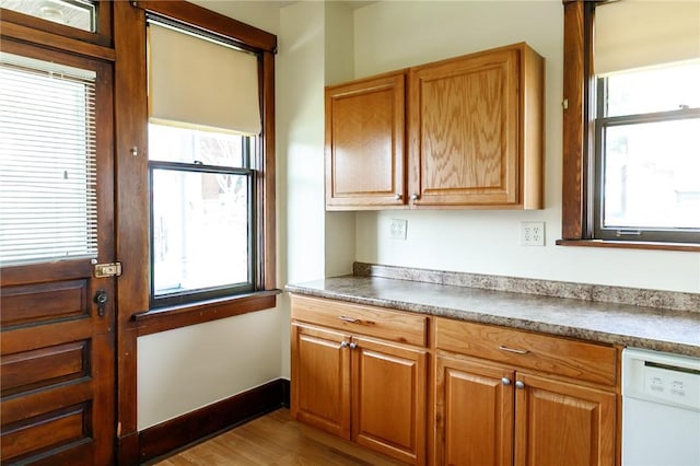 315 Wright St, Mckees Rocks, PA 15136 - kitchen featuring dishwasher, plenty of natural light, wood finished floors, and brown cabinets