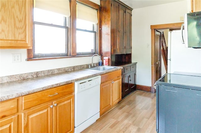 315 Wright St, Mckees Rocks, PA 15136 - kitchen featuring white appliances, a sink, light wood-type flooring, light countertops, and baseboards