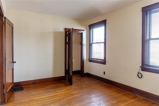 315 Wright St, Mckees Rocks, PA 15136 - unfurnished bedroom featuring multiple windows, light wood-style flooring, and baseboards