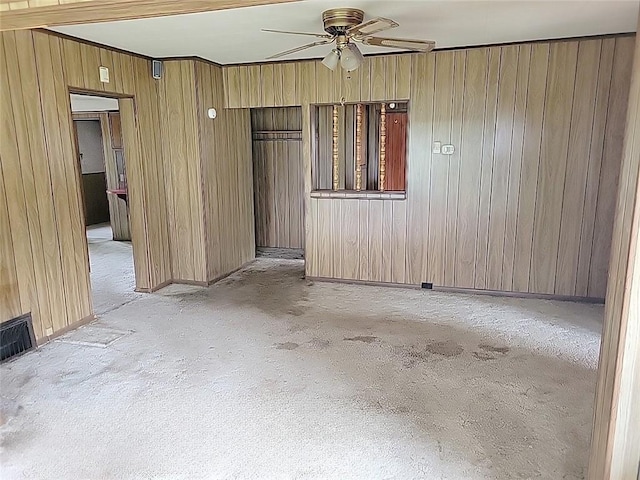 214 Washington Ave, Mount Pleasant Twp Was, PA 15340 - unfurnished room with ceiling fan, wood walls, light colored carpet, and baseboards