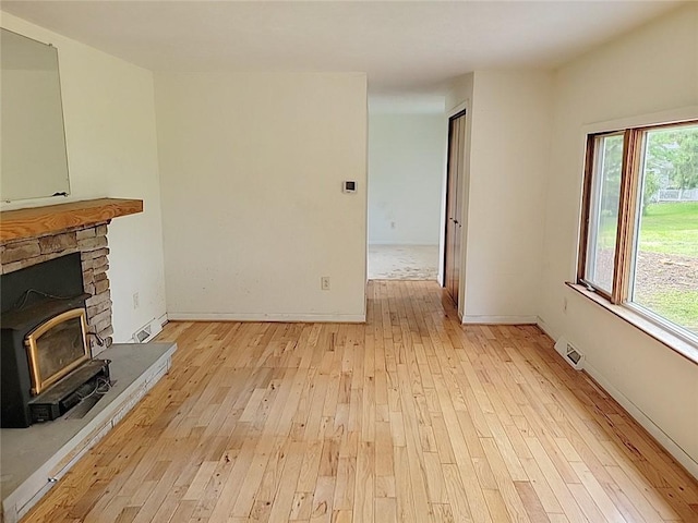 214 Washington Ave, Mount Pleasant Twp Was, PA 15340 - unfurnished living room featuring light wood finished floors, plenty of natural light, and baseboards